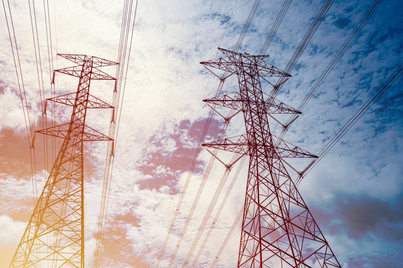 Transmission towers across an evening sky